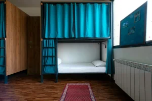 Female Dormitory Bed with Curtains Drawn in Sarv