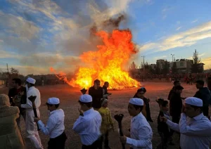 People gathered around a bonfire during Sadeh